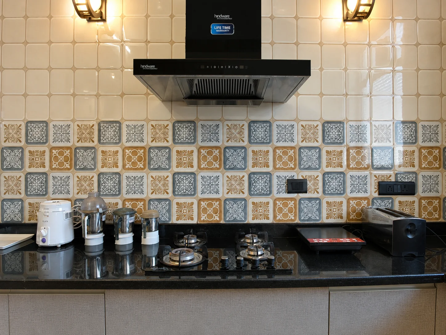 Fully functional kitchen layout with chimney and hob at our luxury homestay in Dehradun